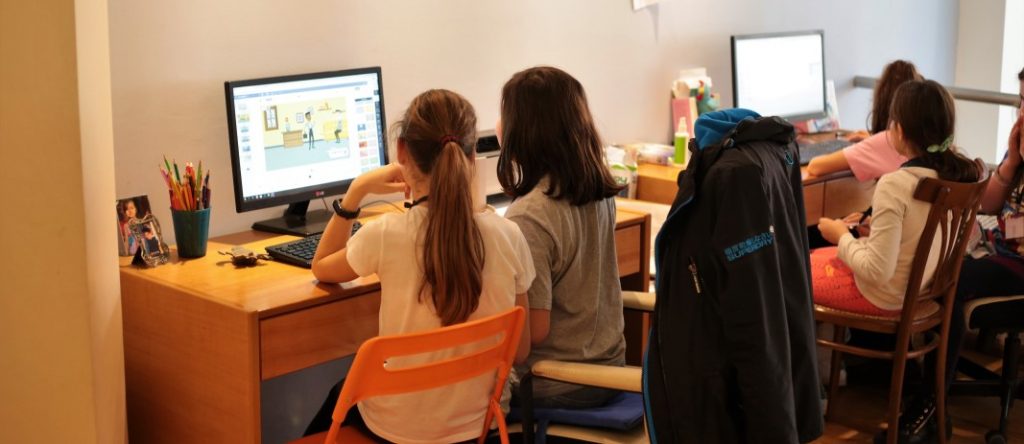 4 students of the 5th grade of mandoulides schools , looking at computer screens while getting informed about the dangers on the Internet