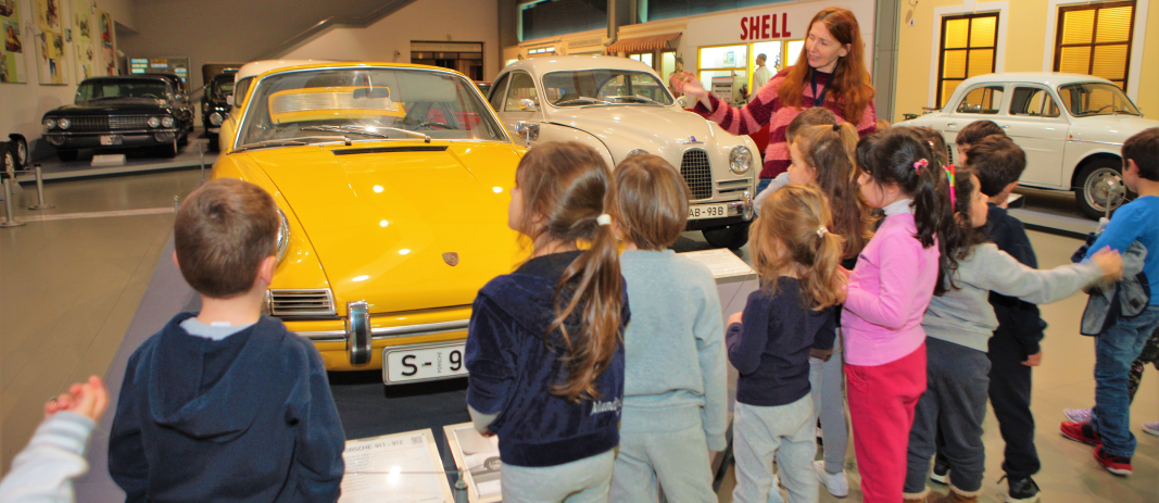 Students of the Beatles of mandoulides schools at the technology museum looking at a yellow car