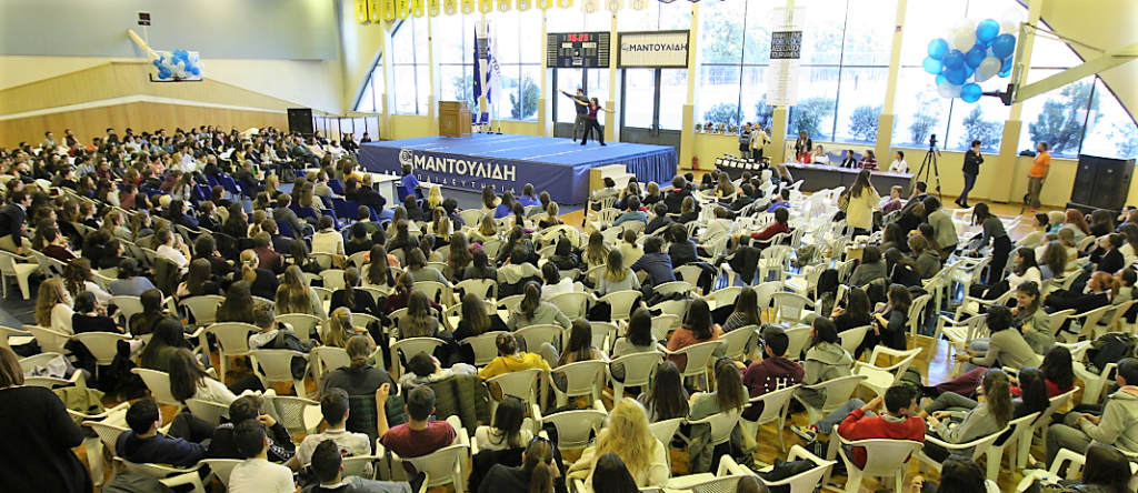 The sports stadium of mandoulides schools full of spectators that watch a duet